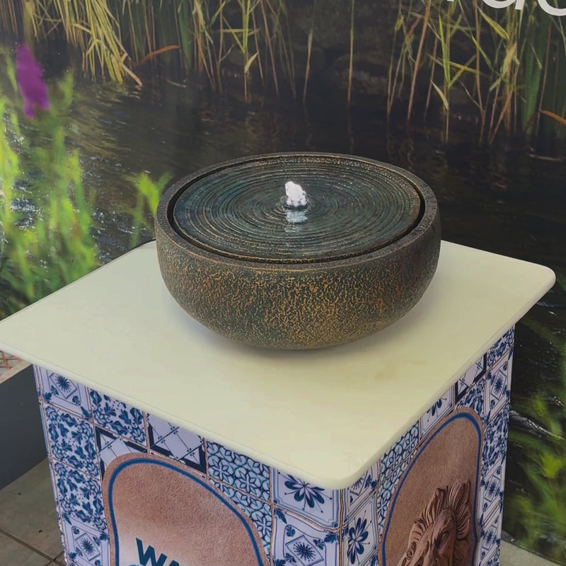 Textured Ripple Bowl Water Feature with concentric circular design and bronze-look finish for indoor or outdoor use
